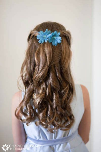 Flower girl with blue flowers in her half-up hairstyle 
