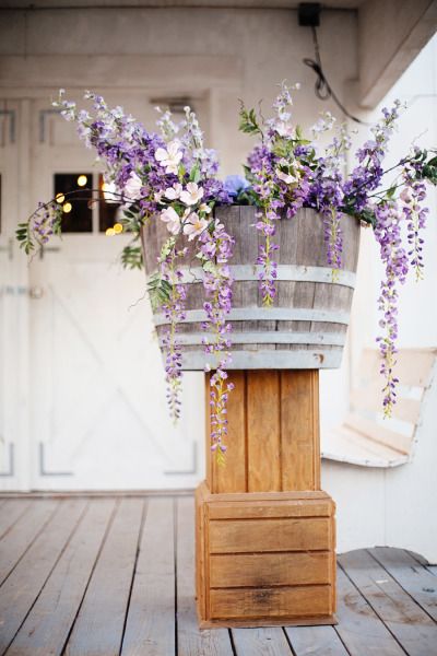 Rustic purple wildflowers with wine barrel and wood boxes